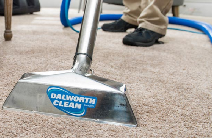 Dalworth's worker cleaning carpet