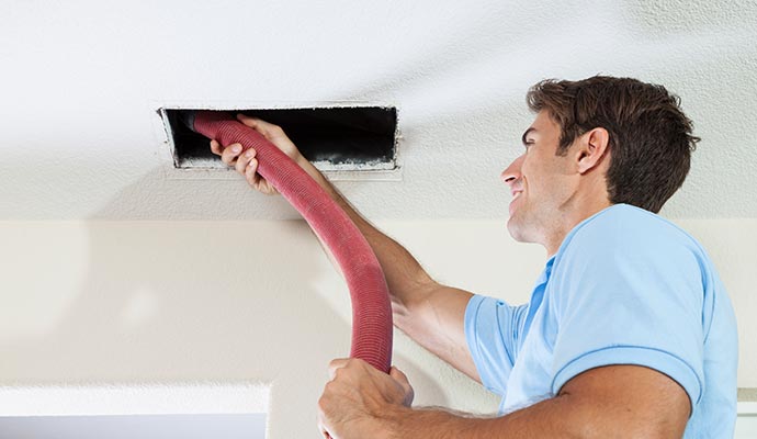 A person is cleaning air duct