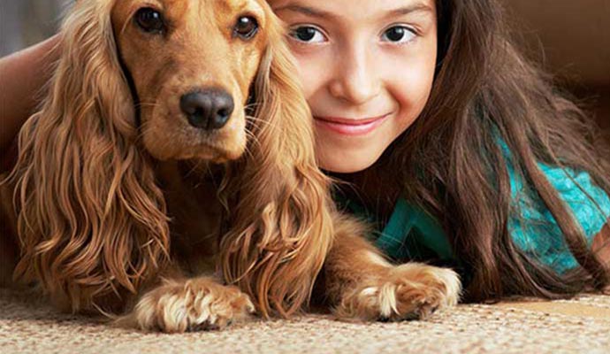 Happy girl with her pet on a odor free carpet