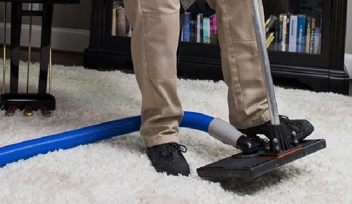 Professional worker performing smoke odor removal in a residential property
