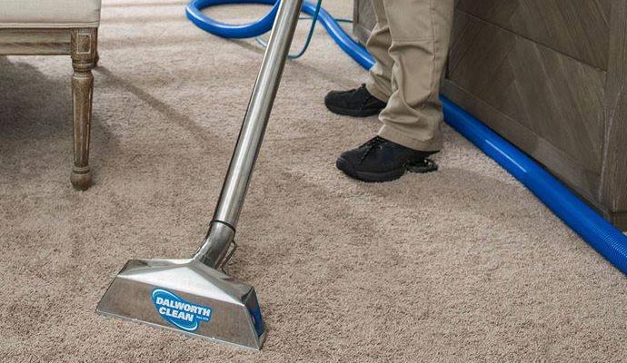 worker cleaning carpet