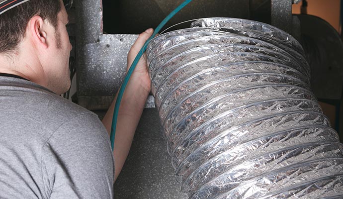 A person is cleaning duct system