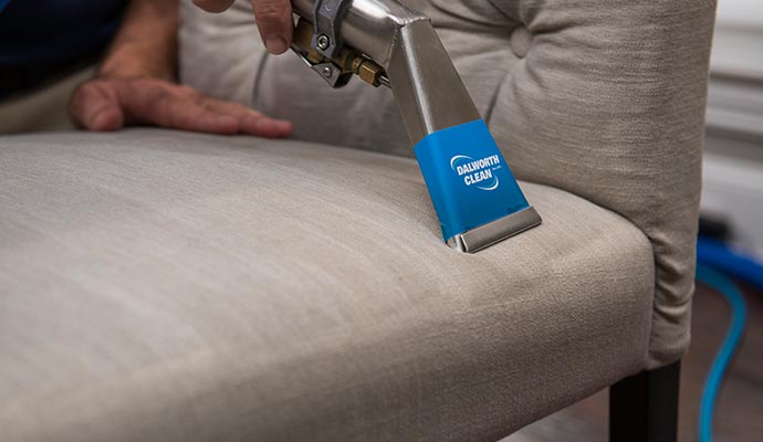 A person is cleaning upholstery