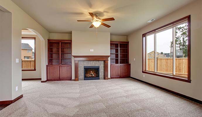 Clean and fresh carpet in a spacious living room with a fireplace
