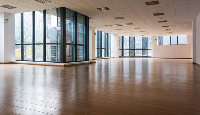 Clean engineered wood flooring in an empty commercial office space