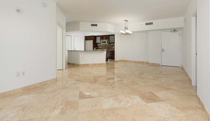 Clean and polished limestone tile floor in an open living space