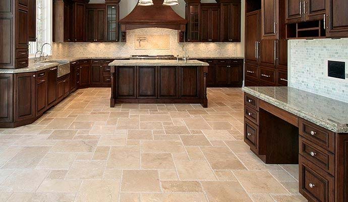 Clean travertine stone tile flooring in a spacious kitchen