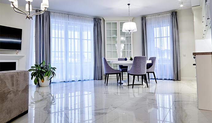 Clean white marble tile floor in a dining room