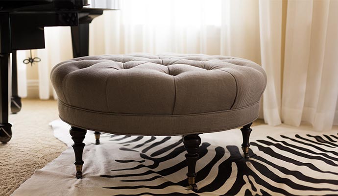 Clean grey tufted ottoman