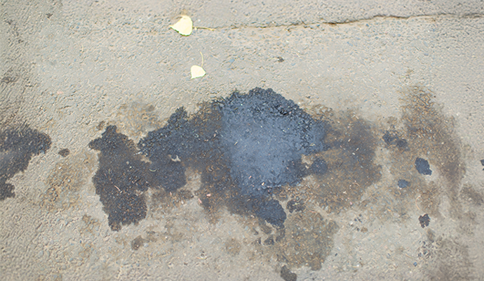 Concrete floor with visible oil and grease stains