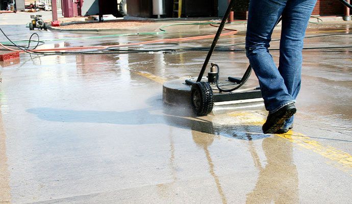 Person cleaning concrete floor