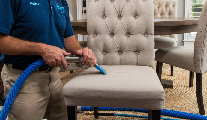 Dalworth technician cleaning tufted dining chair