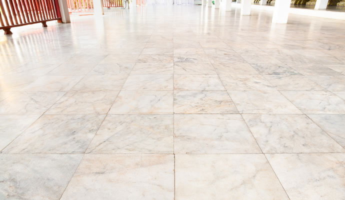 Polished white marble tile flooring in spacious commercial hall