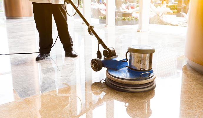 Expert providing professional marble floor cleaning service using specialized equipment
