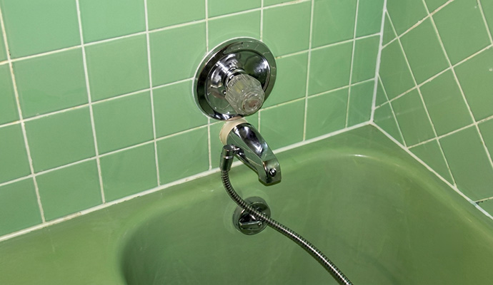 Clean white grout near a bathtub faucet