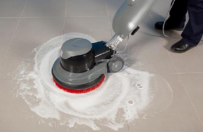 Professional Man Cleaning Tile Floor With Machine