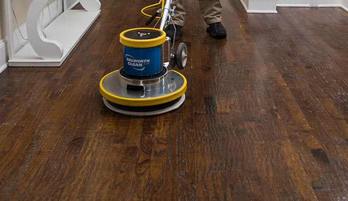 cleaning wood floor with equipment