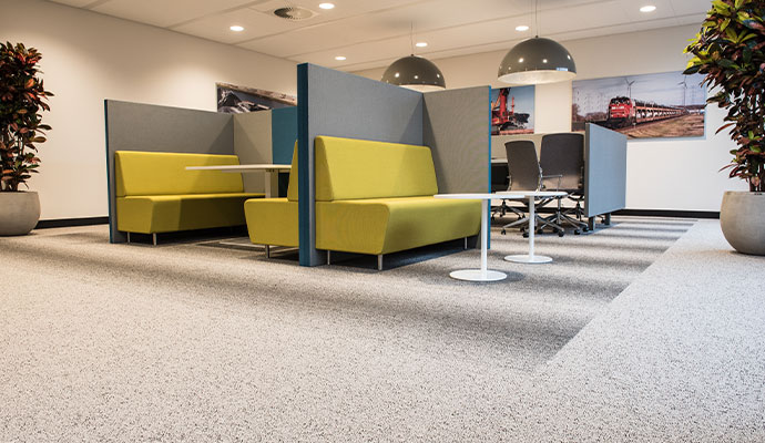 Yellow fabric booths sit in an office.